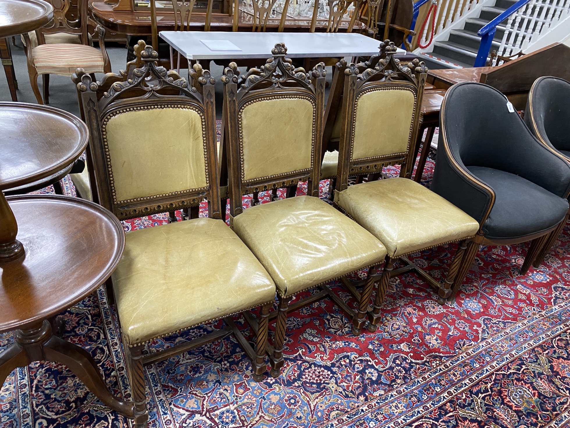 A set of six late Victorian carved walnut Gothic style dining chairs, width 40cm, height 107cm